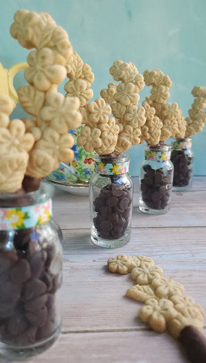 Shortbread flower cookies dipped in chocolate in bud vase